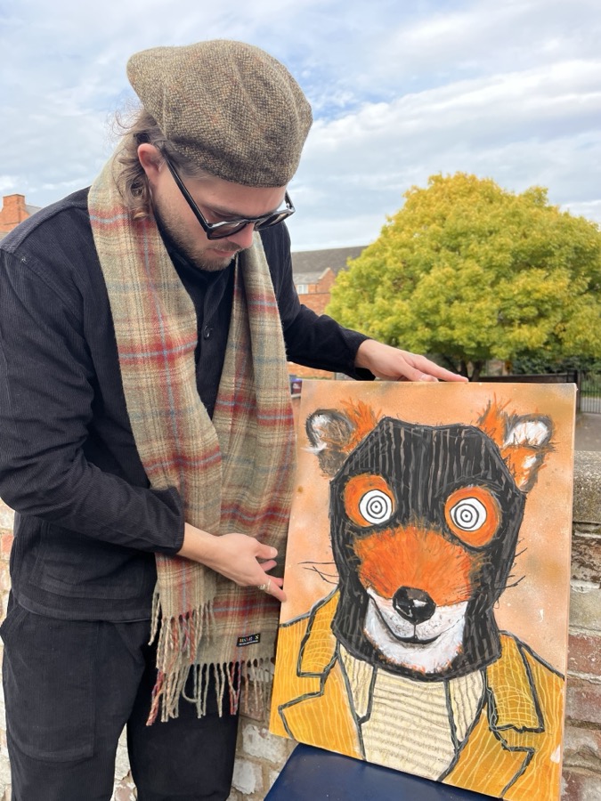 Ben holding his fox character canvas, bold colour and black outlines