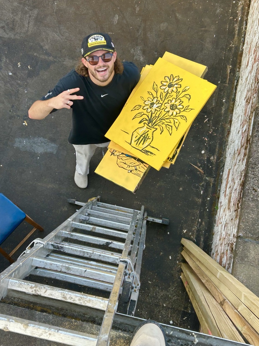 Ben McDonald, co-founder of Patricia Studios, holding the stencils he hand-cut