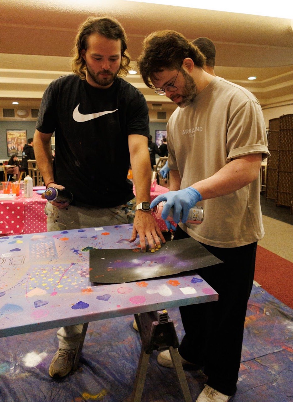 A corporate team painting together at Patricia Studios tables