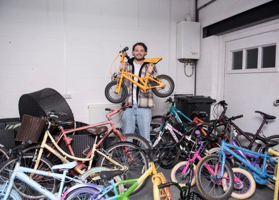 Ben surrounded by colourful bikes at a corporate community event