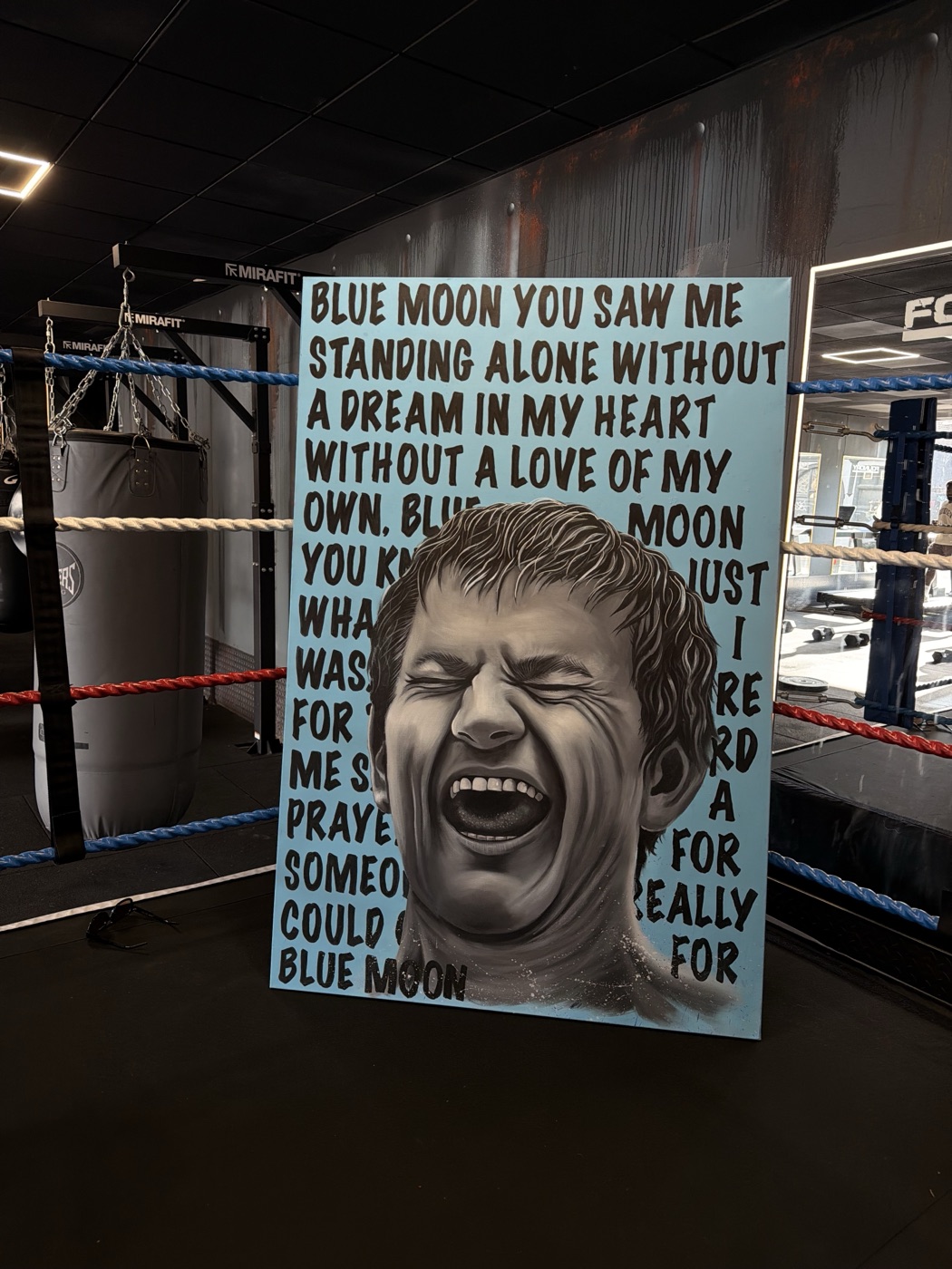 A monochrome canvas of Ricky Hatton mid-roar, wrapped in the words of Manchester’s ‘Blue Moon’