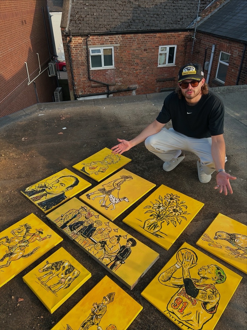 Ben with a rooftop full of finished yellow-ground canvases, his signature colour and outline style