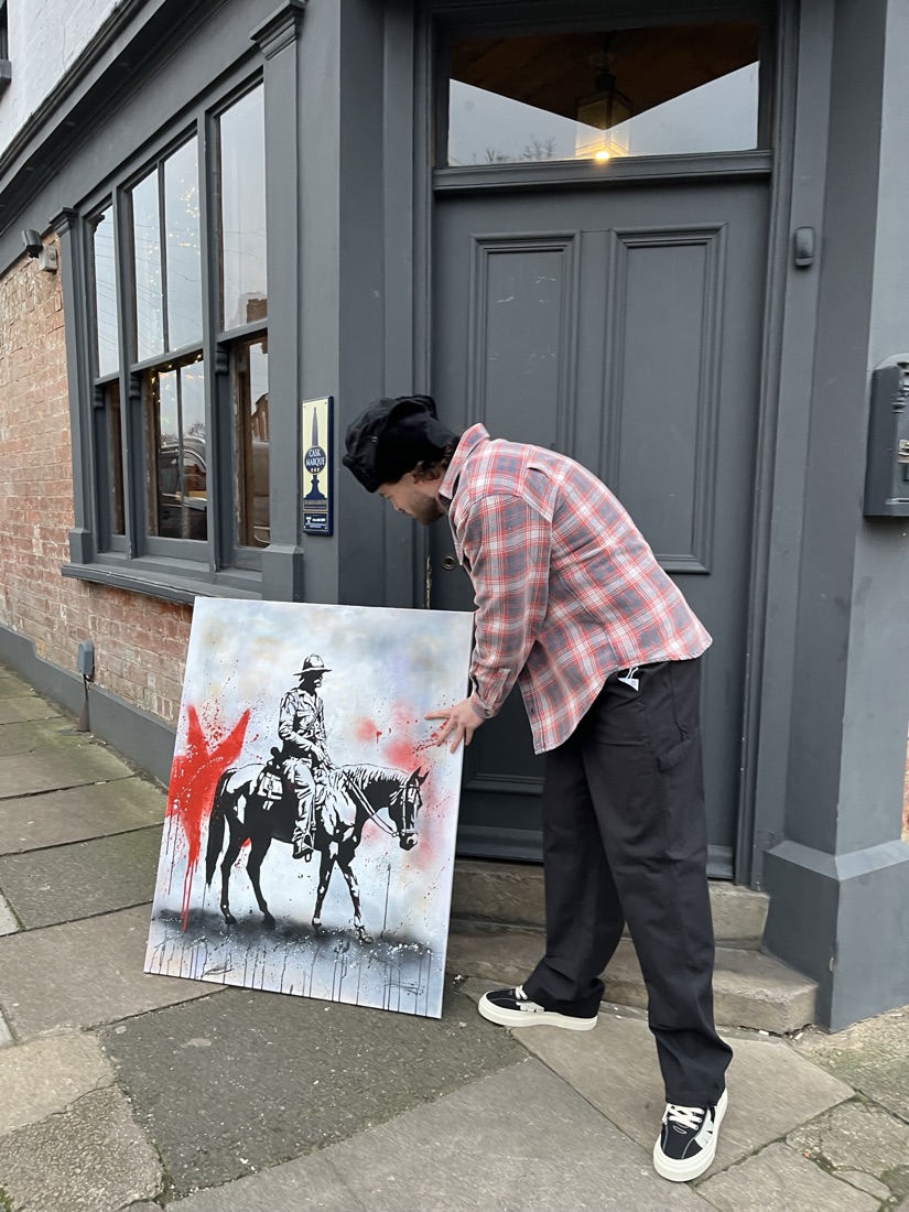 Ben's stencil-style painting of a soldier on horseback, red spray accents