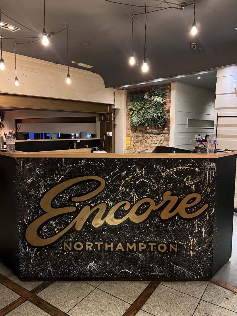 The Encore Northampton bar front, hand-painted gold lettering on black