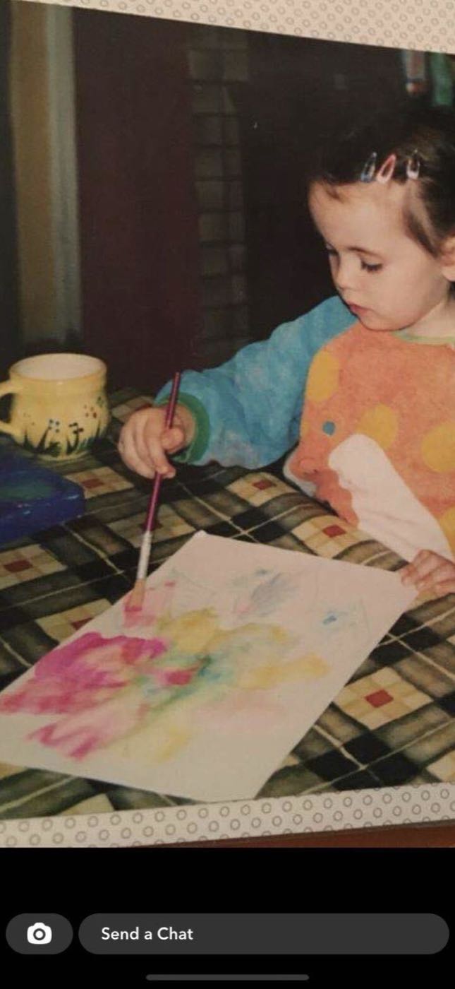 Niamh as a young girl, happiest with a paintbrush in her hand