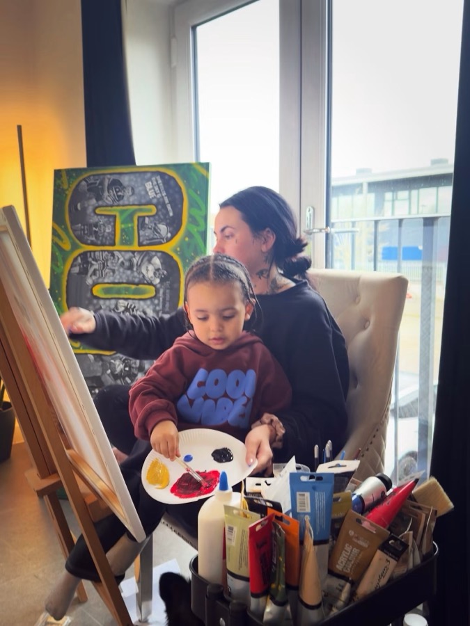 Niamh at the easel, guiding her son Jacques through his first painting, the next generation