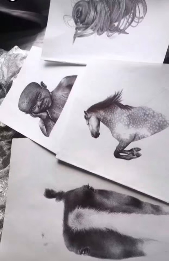 Several pencil drawings by Niamh spread out, showing her developing portfolio
