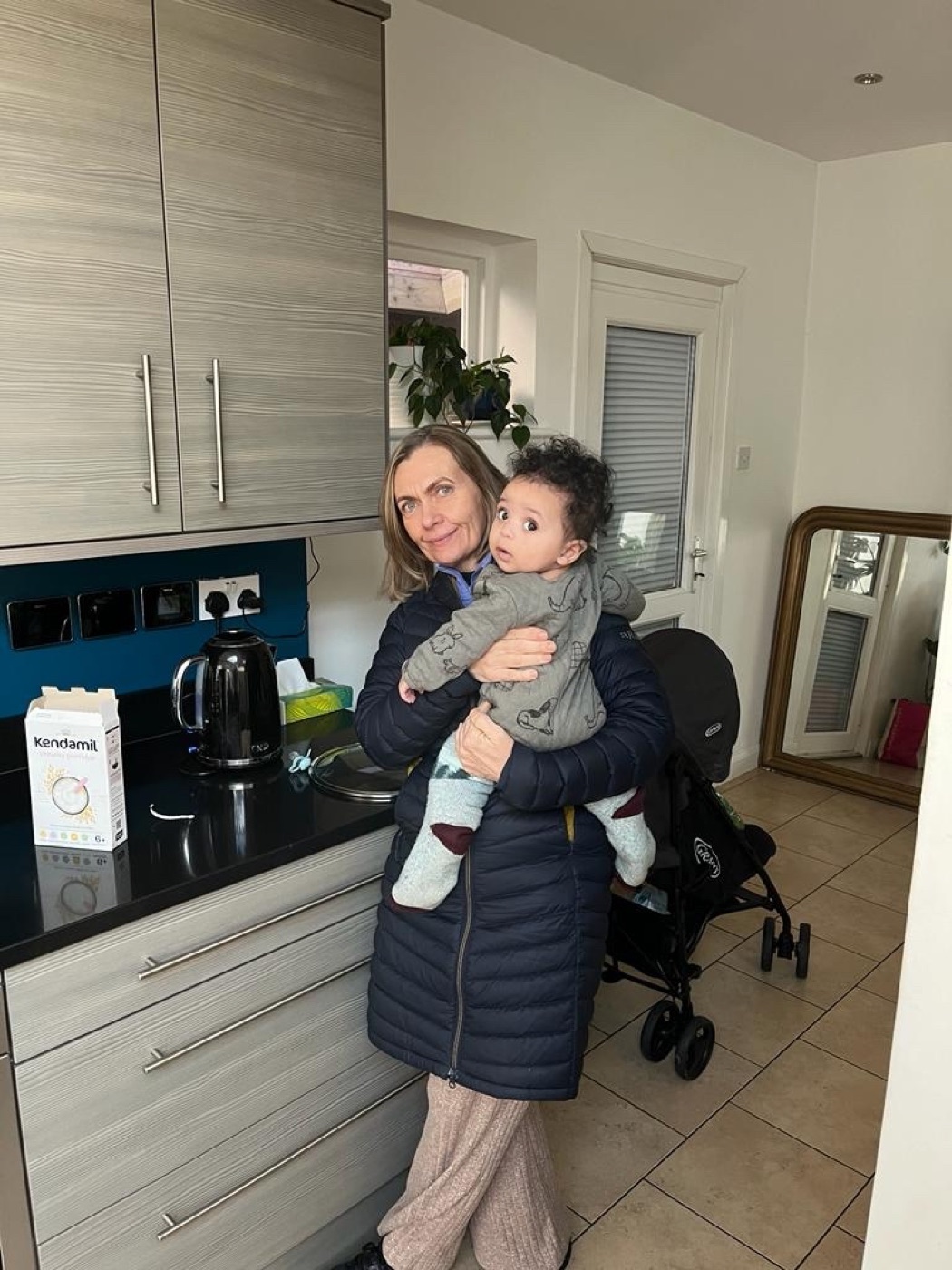 Niamh’s mum, Patricia, holding her grandson Jax at home